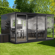 Backyard studio setup featuring the 13x10 Duramax glass room with office desk and dining area.