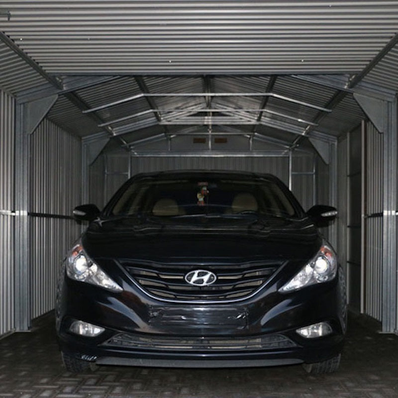 Interior view of Duramax Imperial 12'x20' garage with a car parked inside, showcasing the spaciousness and metal structure.