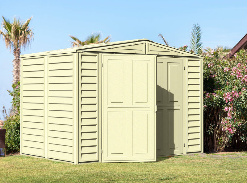 Semi-open door view of Duramax Duramate 8'x5.3' Vinyl Shed outdoors, emphasizing the shed's practical design and fit in natural settings.