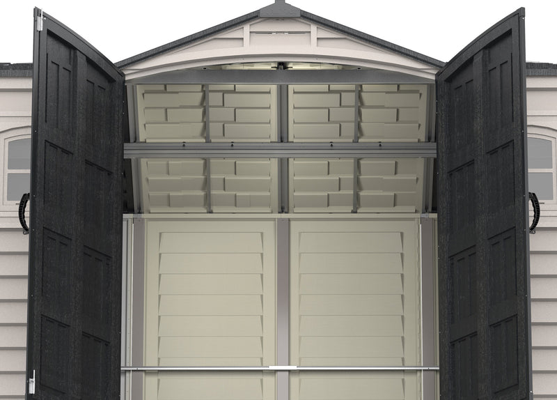Interior of a Duramax Apex Pro 10.5x8 ft. outdoor shed with double doors open, showcasing shelves and storage space.