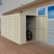 Open door view of the Duramax SideMate 4'x10' Vinyl Resin Outdoor Storage Shed on a wooden deck, displaying a bicycle storage option and robust design.