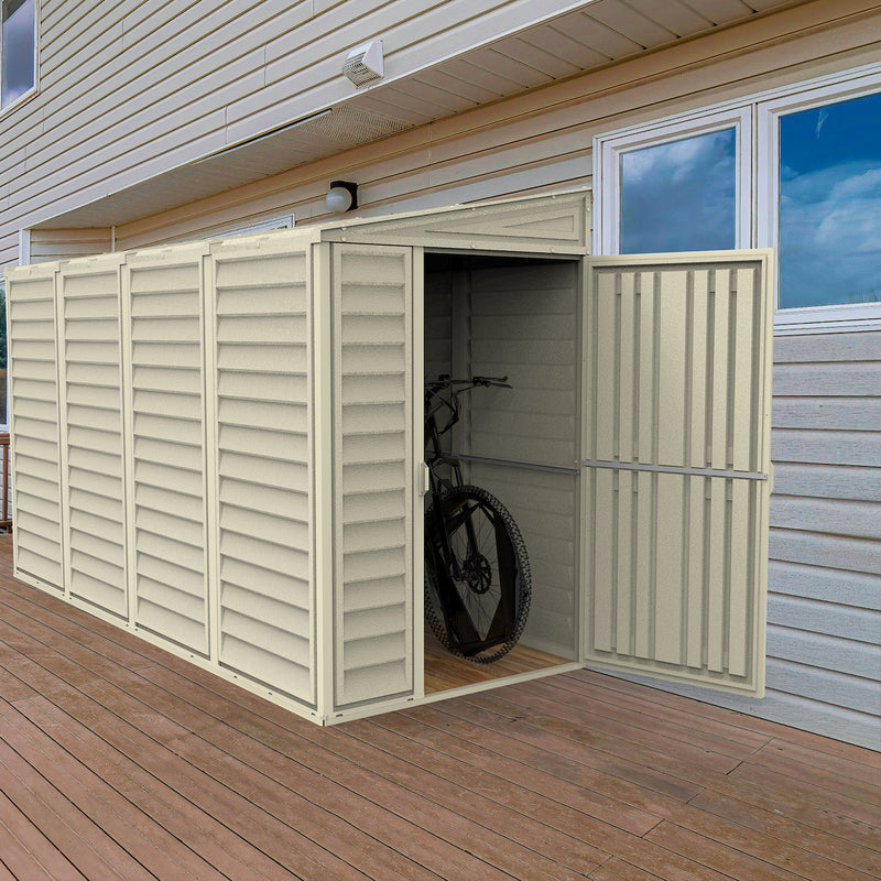 Open door view of the Duramax SideMate 4'x10' Vinyl Resin Outdoor Storage Shed on a wooden deck, displaying a bicycle storage option and robust design.