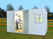 Duramax Flat Roof Building 19x10 - Backyard Oasis placed outdoors with light and things inside