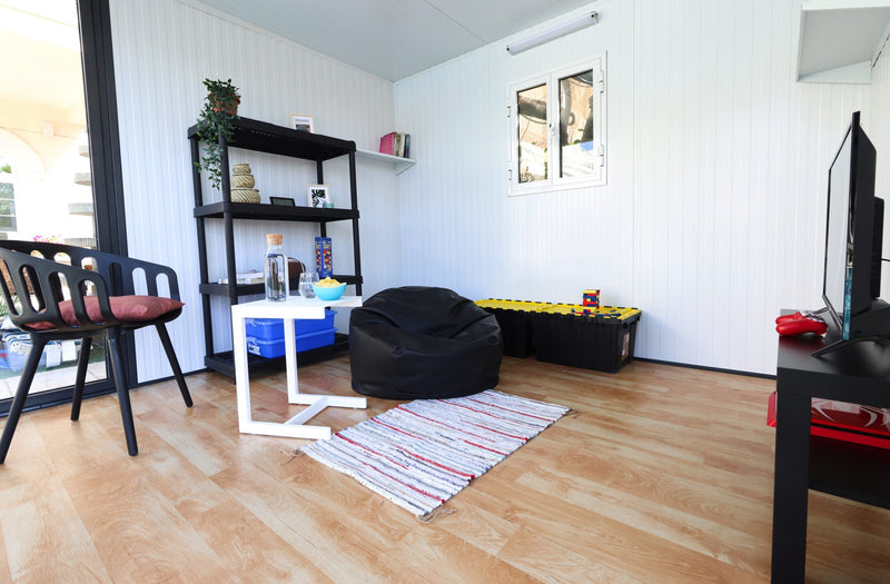Duramax insulated glass building 10x10 living room setup side view kids chill room side view