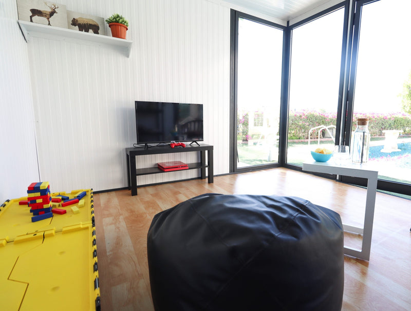 Duramax insulated glass building 10x10living room setup side view kids chill room sideview