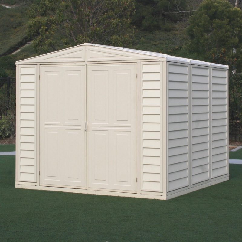 Duramax Duramate 8'x8' Vinyl Storage Shed beautifully integrated in a natural forest setting, highlighting its versatility and aesthetic appeal.