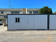 Front view of one unit in a twin setup of Duramax Insulated Glass Building 13'x10' outside a police department.