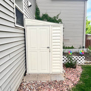 Duramax SideMate Shed with Foundation 4'x8' (06625) installed in a narrow side yard with stone landscaping and a garden backdrop.