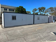 Two Duramax Insulated Glass Buildings 13'x10' joined side by side to create a larger structure in a wide open lot.