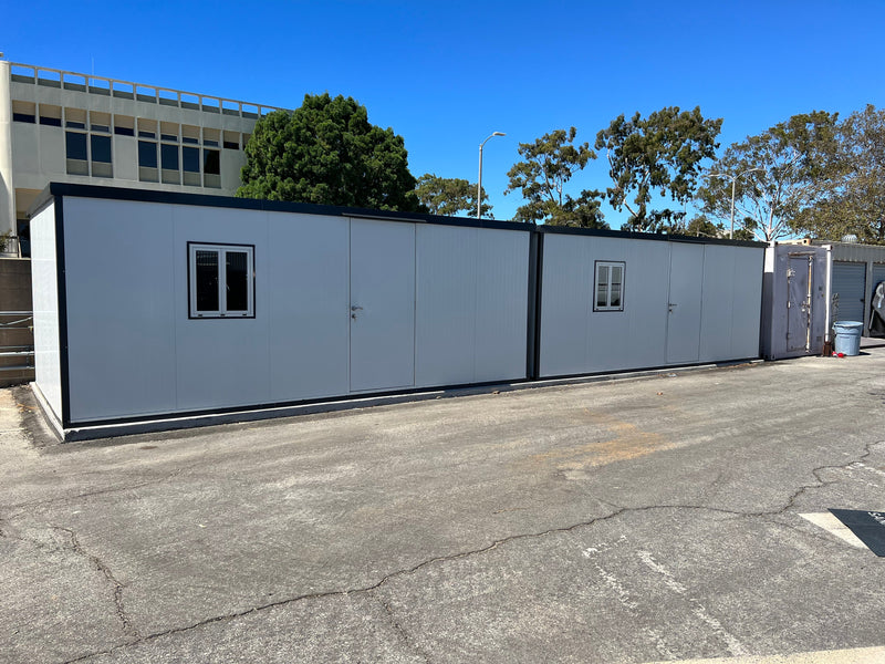 Two Duramax Insulated Glass Buildings 13'x10' joined side by side to create a larger structure in a wide open lot.