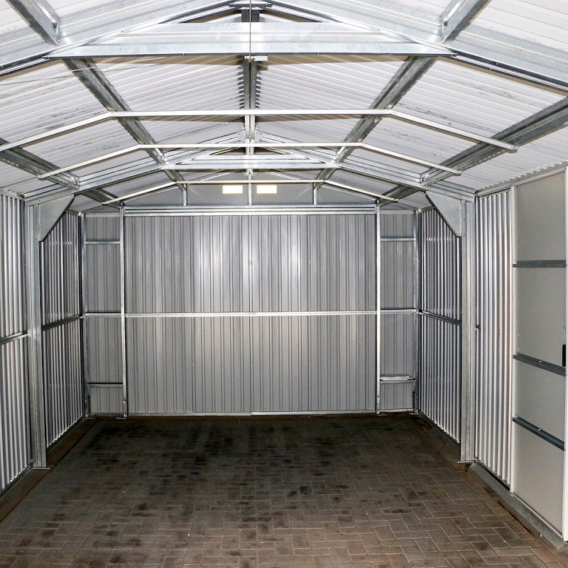Inside view of an empty Duramax Imperial 12'x20' metal garage, emphasizing the interior space and metal shelving.