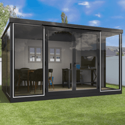 Duramax 13x10 insulated glass room used as a home office and dining space in a backyard.
